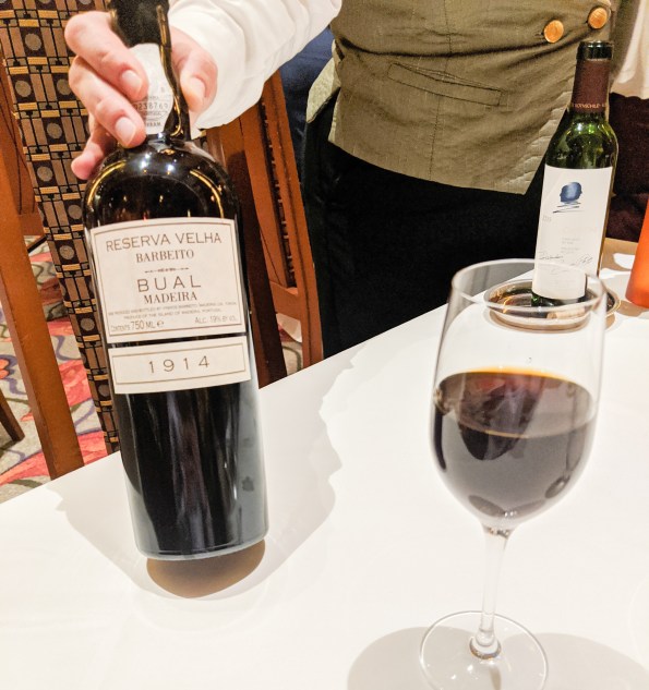 A bottle of 1914 Madeira wine being served